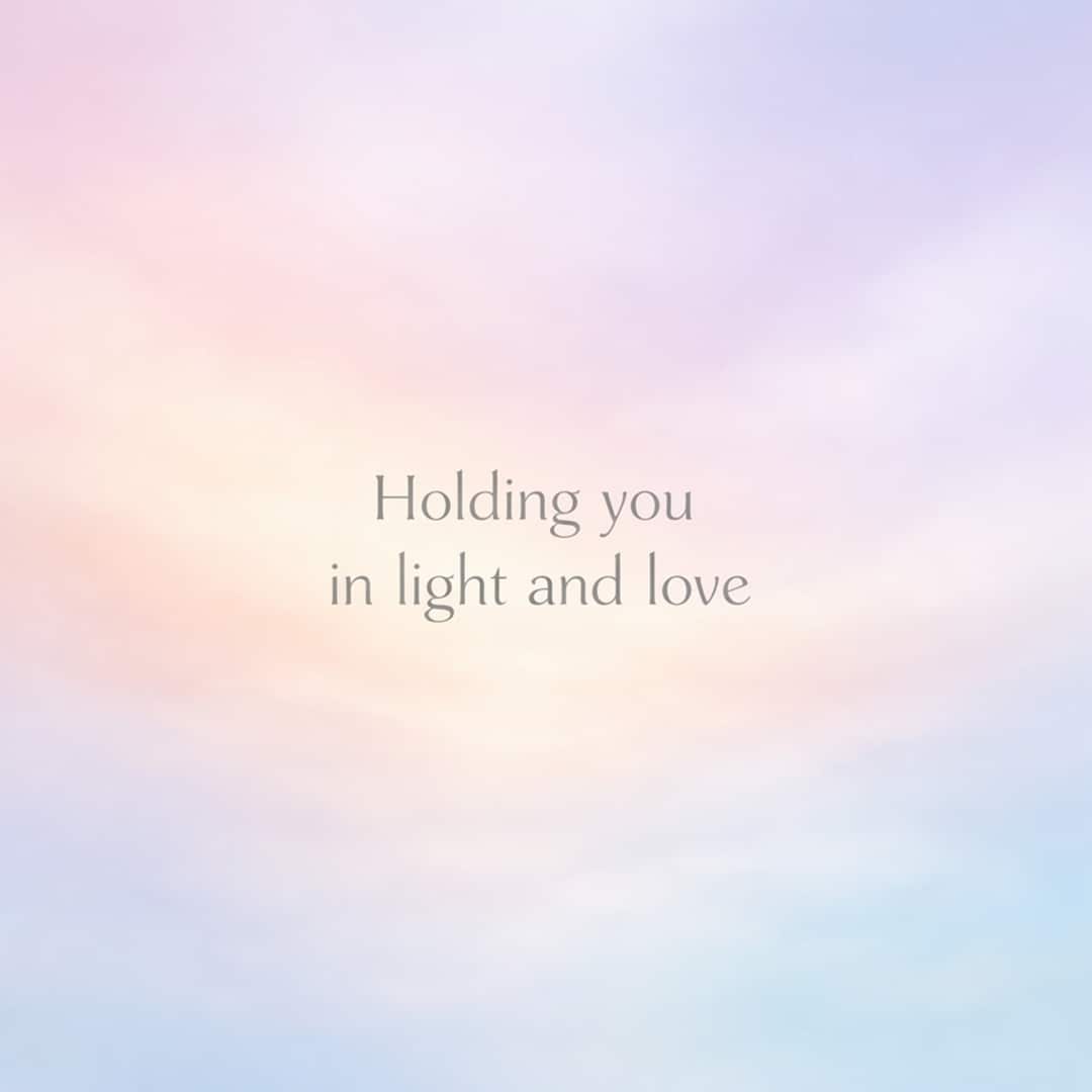 holding you in light and love sympathy message on soft pastel gradient background