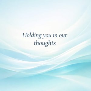 holding you in our thoughts sympathy message on soft abstract light background