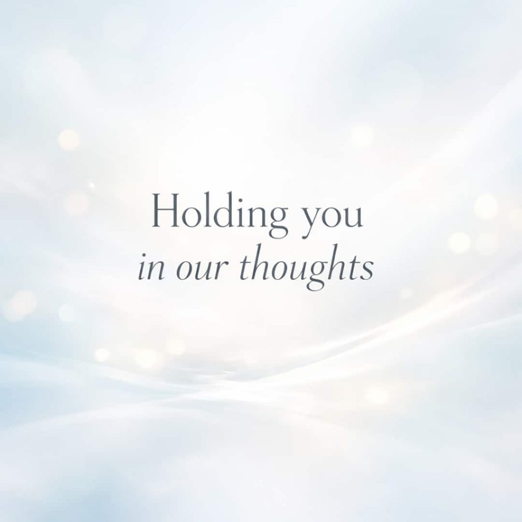 holding you in our thoughts sympathy message on soft abstract light background