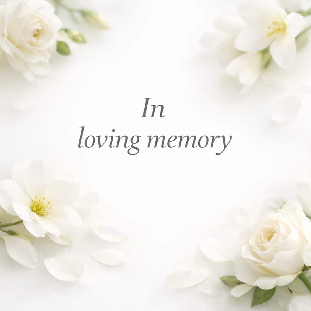 in loving memory sympathy message with soft white flowers on light background